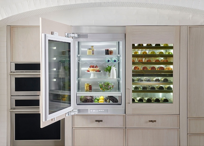 Built in refrigerator opened, revealing fridge full of food